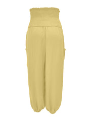 Yellow smocked waist harem pants with pockets and ankle cuffs.