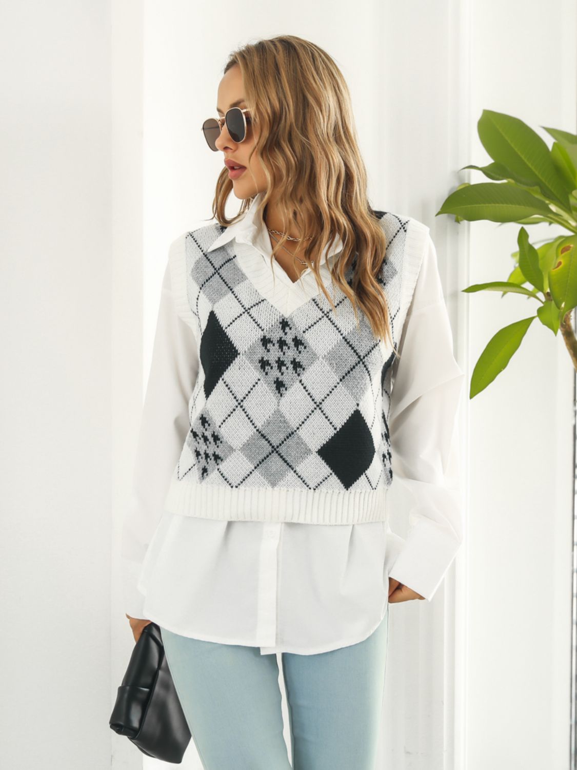 Argyle knit cropped sweater vest in white with black and grey diamond pattern.