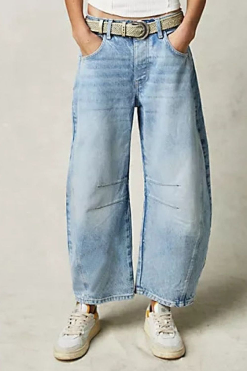 Light blue denim barrel leg jeans with button fly and knee detail