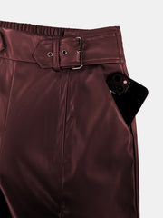 Burgundy faux leather palazzo trousers with belted waist and pocket detail.