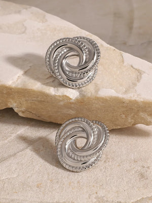 Silver swirl knot stud earrings with textured rope edge detail
