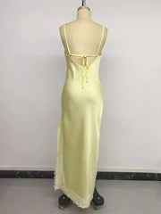 Yellow lace-trimmed midi slip dress with side slit and tie back.