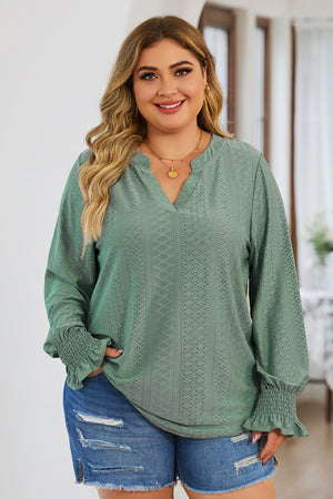 Sage green textured slit-neck blouse with shirred cuffs and eyelet pattern.