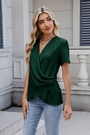 Dark green short sleeve blouse with draped front and V-neck.