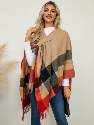 Asymmetric plaid fringe cape in tan with red, black, and yellow checkered pattern.