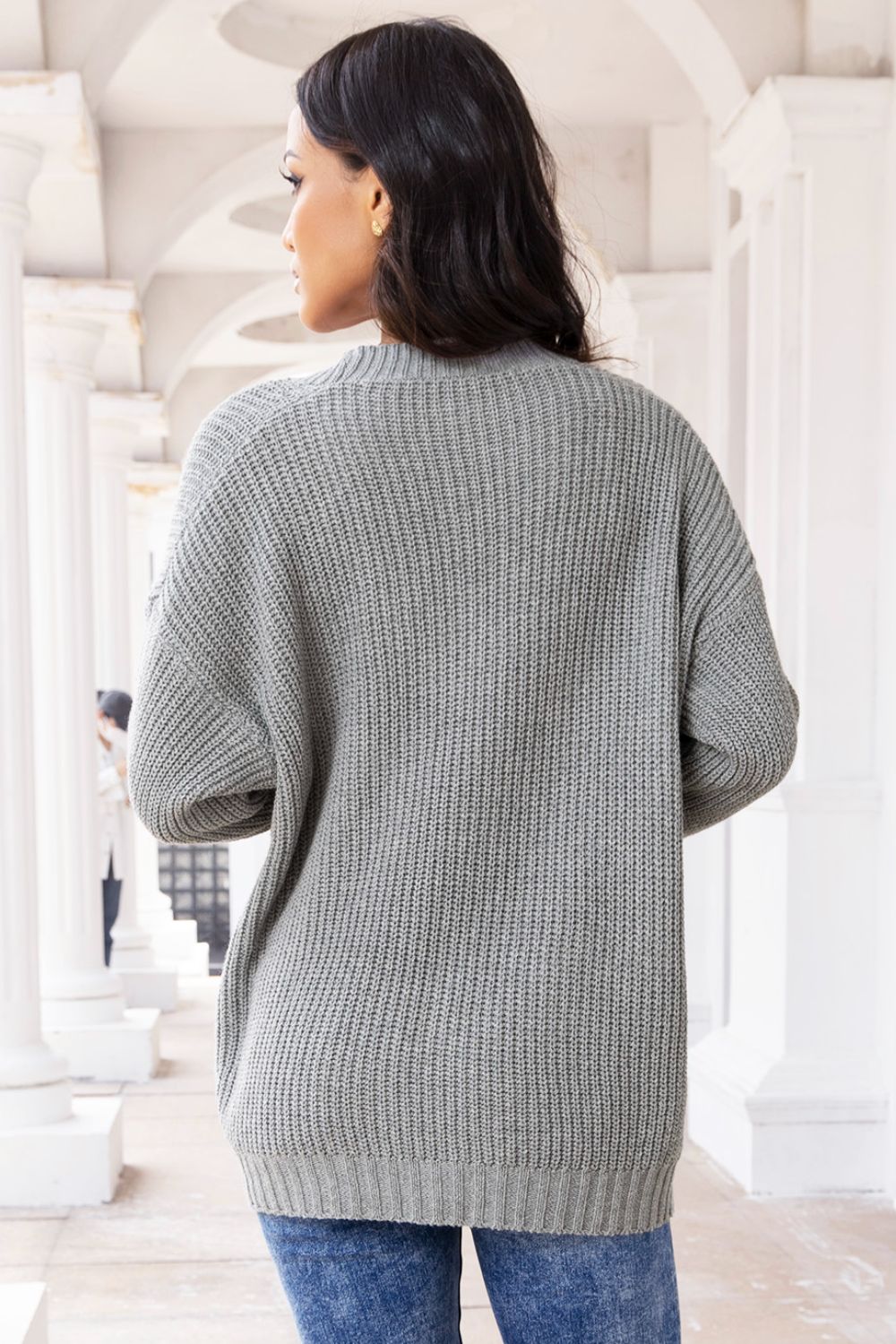 Dark gray oversized ribbed knit cardigan with pockets and button front.