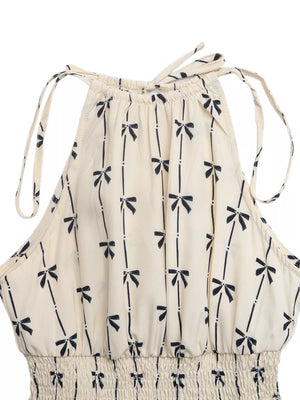 Charming Bow Print Smocked Halter Romper in apricot with tie straps and smocked waist.