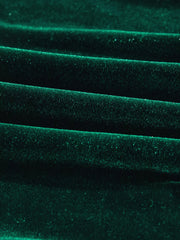 Dark green velvet fabric with subtle sparkle detail, showing textured folds.