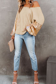 Tan waffle knit off-shoulder top with sequin bell sleeves