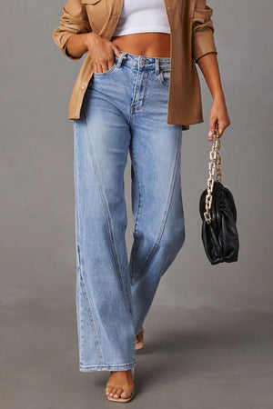 Light wash denim jeans with wide legs and panel seam details.