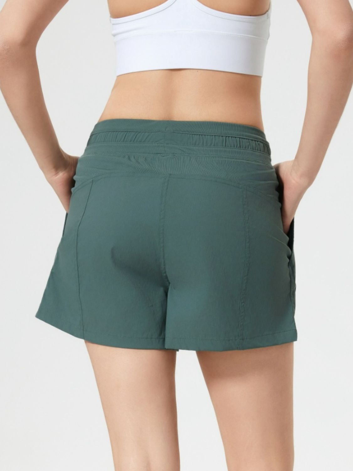 Coastal drawstring utility shorts in dark green with pockets and elastic waistband.