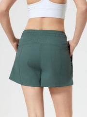 Coastal drawstring utility shorts in dark green with pockets and elastic waistband.
