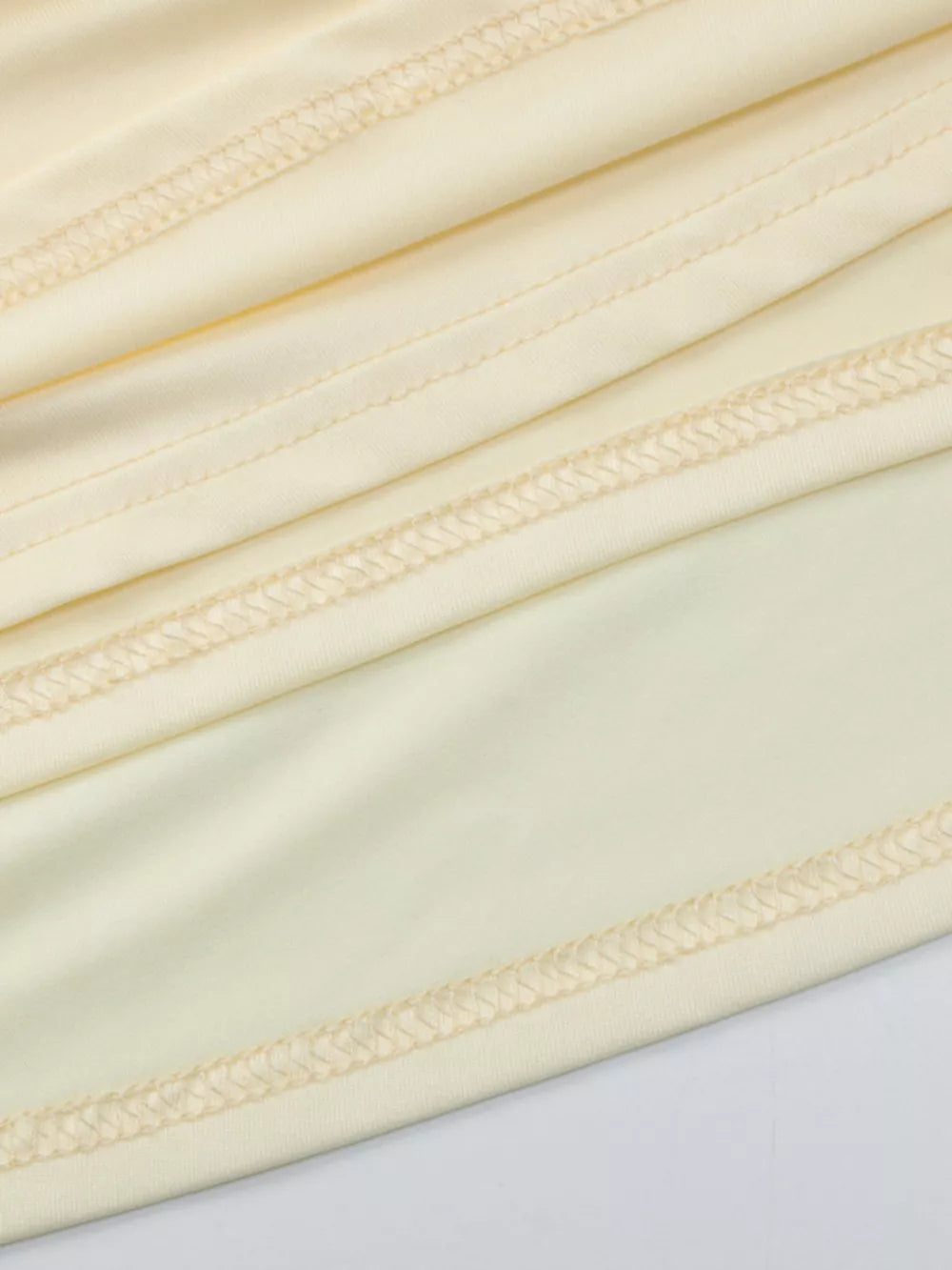 Yellow ruched maxi dress detail with visible stitching