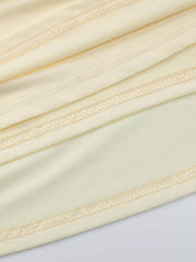 Yellow ruched maxi dress detail with visible stitching