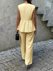Yellow peplum hem two-piece set with button detail, cap sleeves, and wide-leg pants.