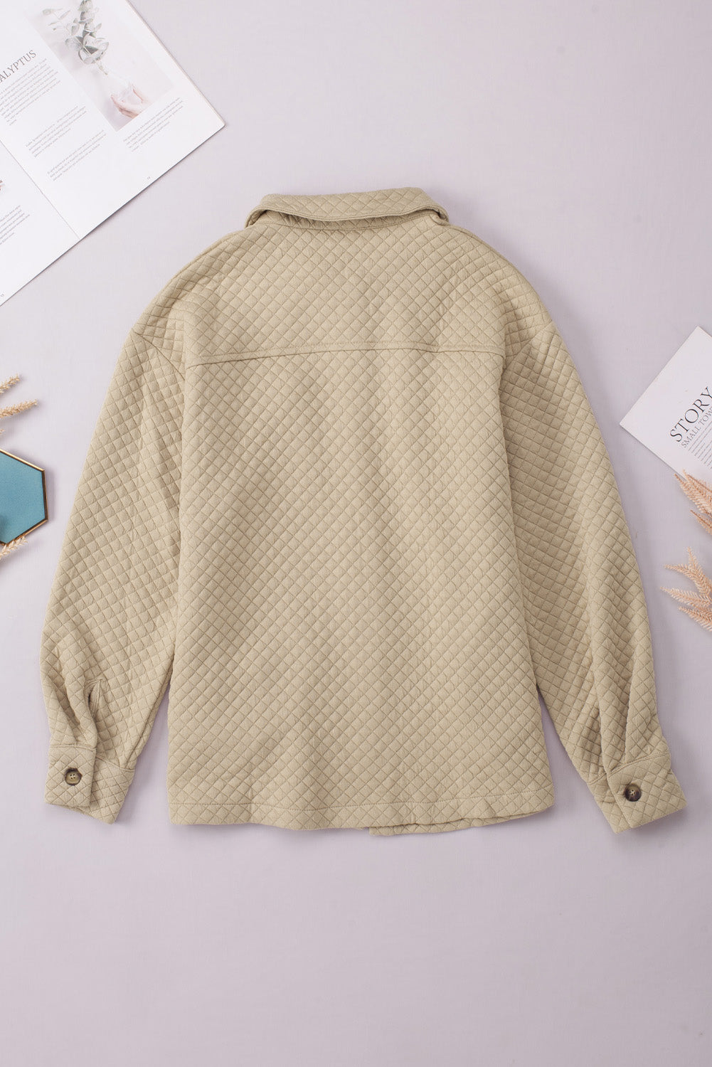 Quilted overshirt in tan with button cuffs and collar.