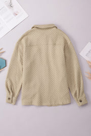 Quilted overshirt in tan with button cuffs and collar.