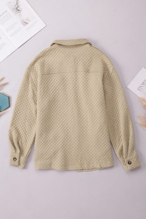 Quilted overshirt in tan with button cuffs and collar.