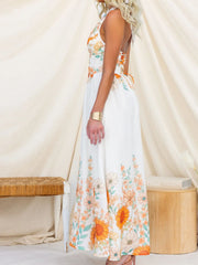 White floral halter neck maxi dress with orange and green floral print