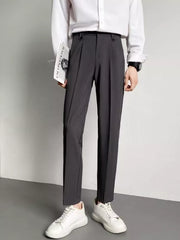 Men's dark gray ankle-length slim fit trousers with double button waist detail.