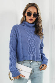 Blue acrylic cable knit cropped turtleneck sweater with braided detail.