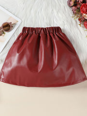 Wine red faux leather toddler skirt with elastic waistband and ruffled detail.