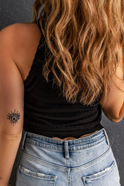 Black scalloped knit halter top with eye tattoo detail on arm