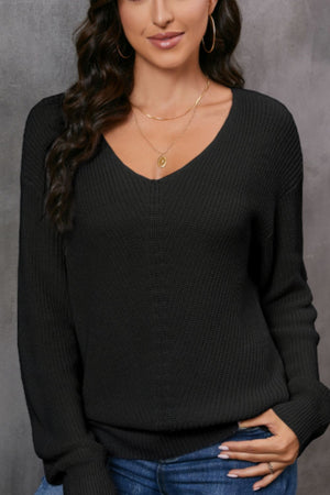 Black relaxed knit v-neck pullover sweater with a subtle center seam detail.