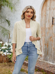 Tan eyelet cascade cardigan with open front and 3/4 sleeves.