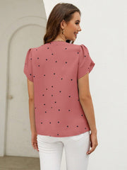 Dusty pink heart print puff sleeve blouse with a V-neckline.