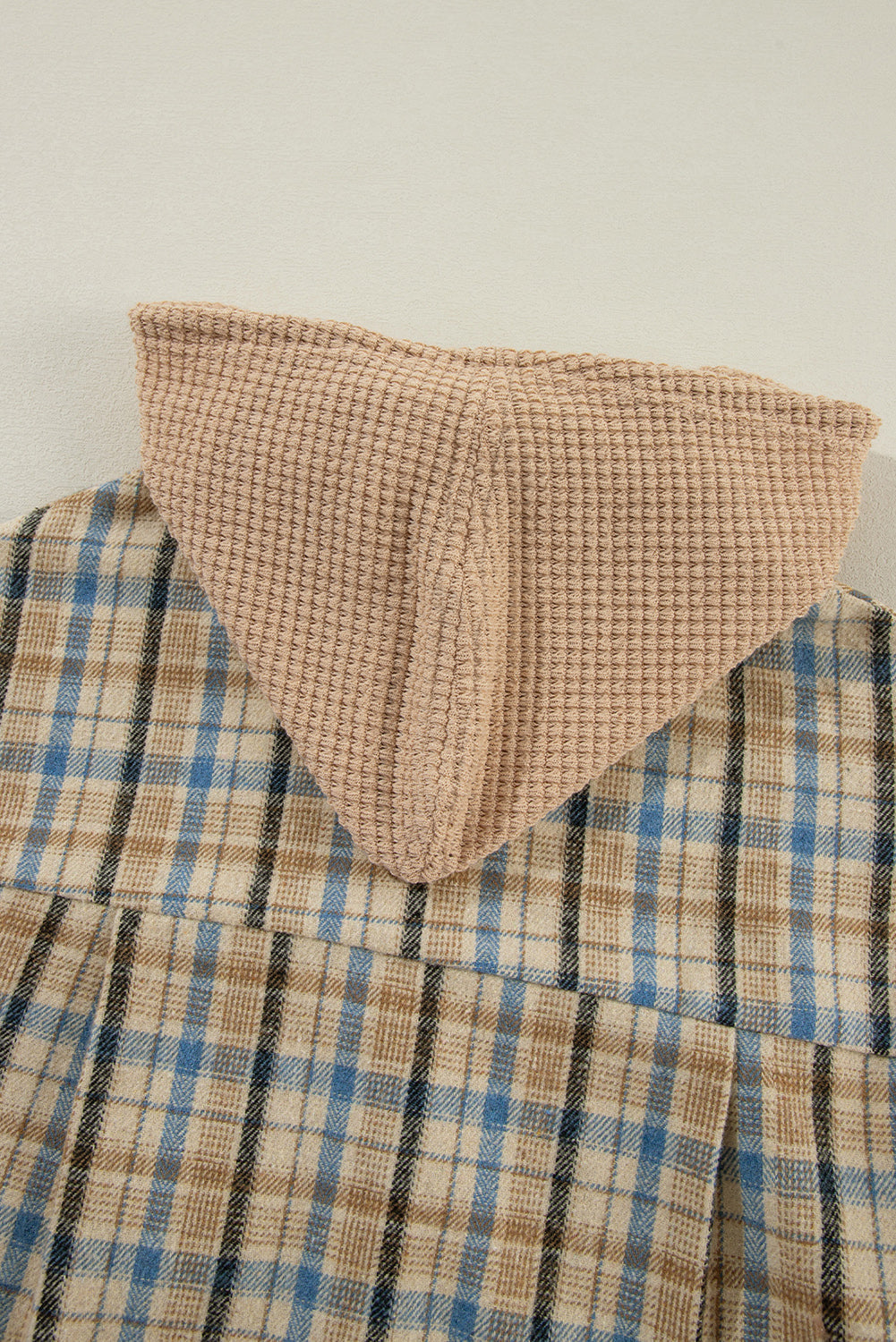 Textured plaid hooded overshirt with raw hem and waffle knit hood detail.