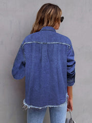 Frayed edge denim overshirt in medium blue cotton, featuring a buttoned front and raw hem.