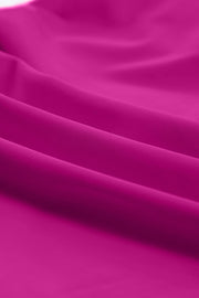 Sculpted tankini with skirted bottom in cerise, showing fabric texture and folds.