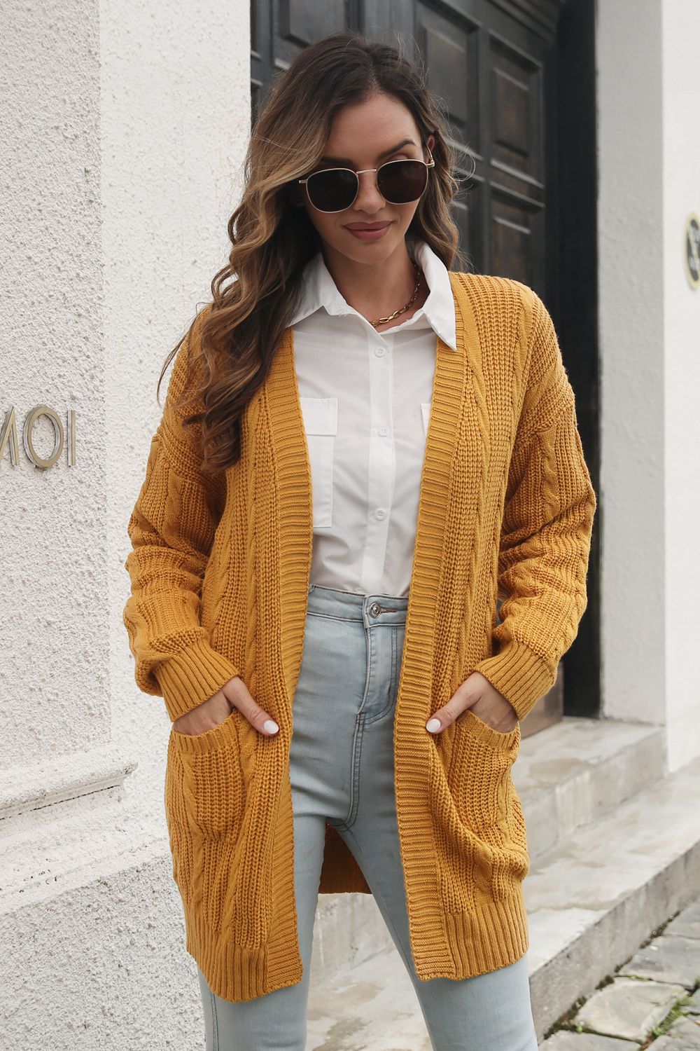 Mustard cable knit longline cardigan with pockets, acrylic material.