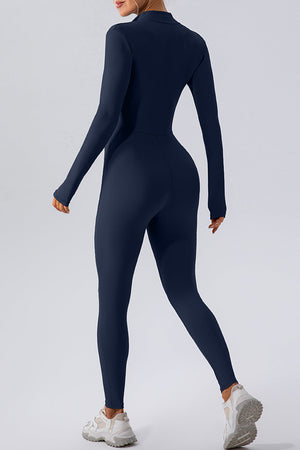 Dark blue zip-front bodycon jumpsuit with long sleeves and a high neckline.