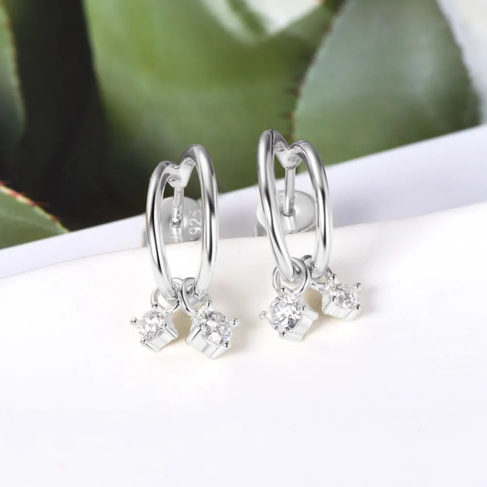 Silver hoop earrings with cubic drop charms and clear stones