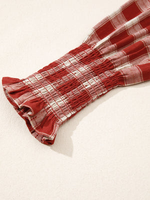 Smocked puff sleeve mini dress in red and white plaid cotton with ruffled cuffs.