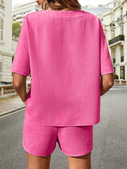 Pink waffle knit drawstring co-ord set with short sleeves and shorts.