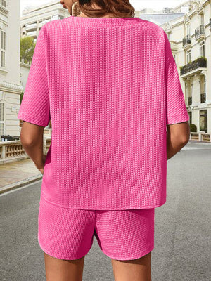 Pink waffle knit drawstring co-ord set with short sleeves and shorts.