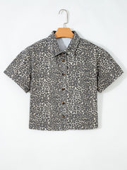 Leopard print denim short-sleeve shirt with button front and chest pocket.