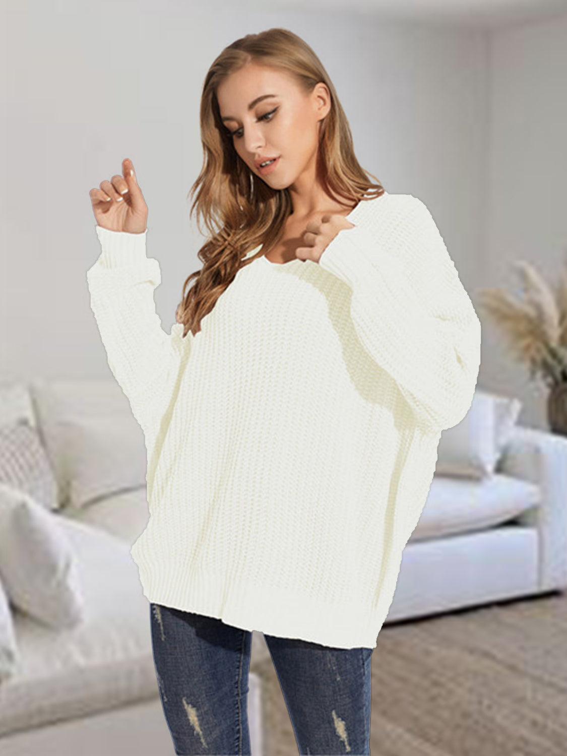 Relaxed fit ivory ribbed knit sweater with V-neck and batwing sleeves.