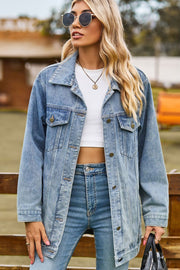 Oversized medium wash denim trucker jacket with classic button front and chest pockets.