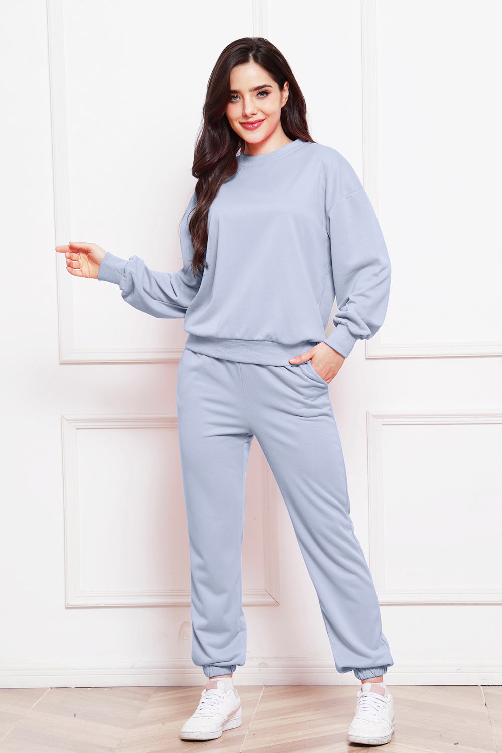 Light blue relaxed fit loungewear set with crewneck sweatshirt and jogger pants.