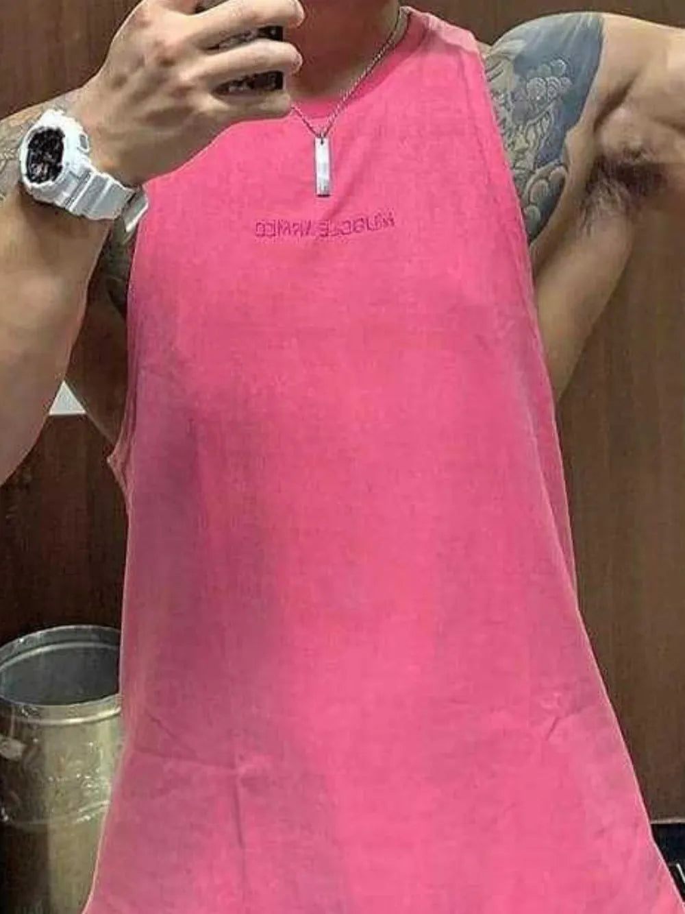 Fuchsia pink muscle armed tank top with embroidered text detail.
