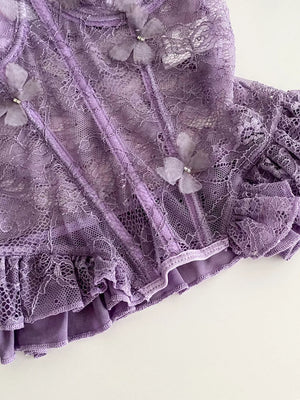 Purple lace bustier top with 3D butterflies, ruffles, and bow details.