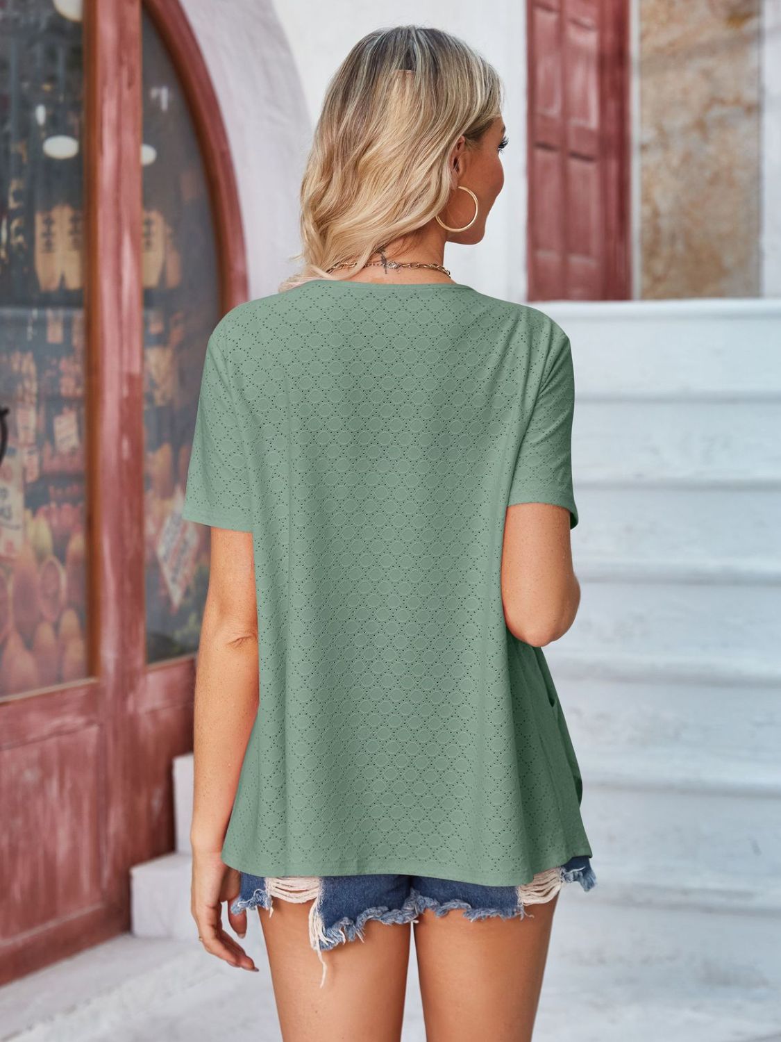 Sage perforated edge shawl collar jacket with short sleeves.