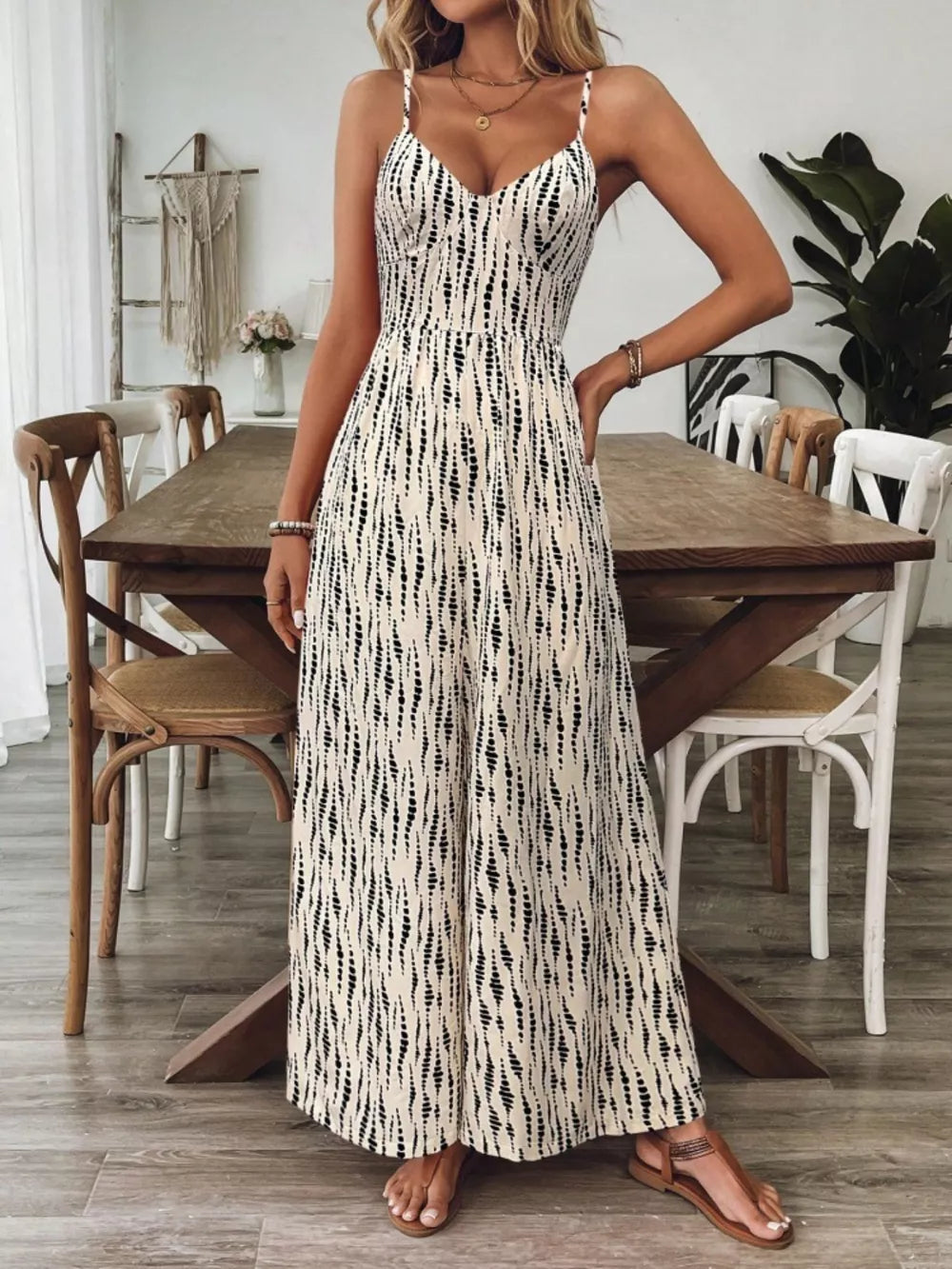 Backless wide-leg jumpsuit with abstract print and spaghetti straps.