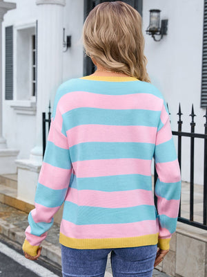 Sweater with pink, blue, and yellow stripes, crew neck, long sleeves, and ribbed cuffs.