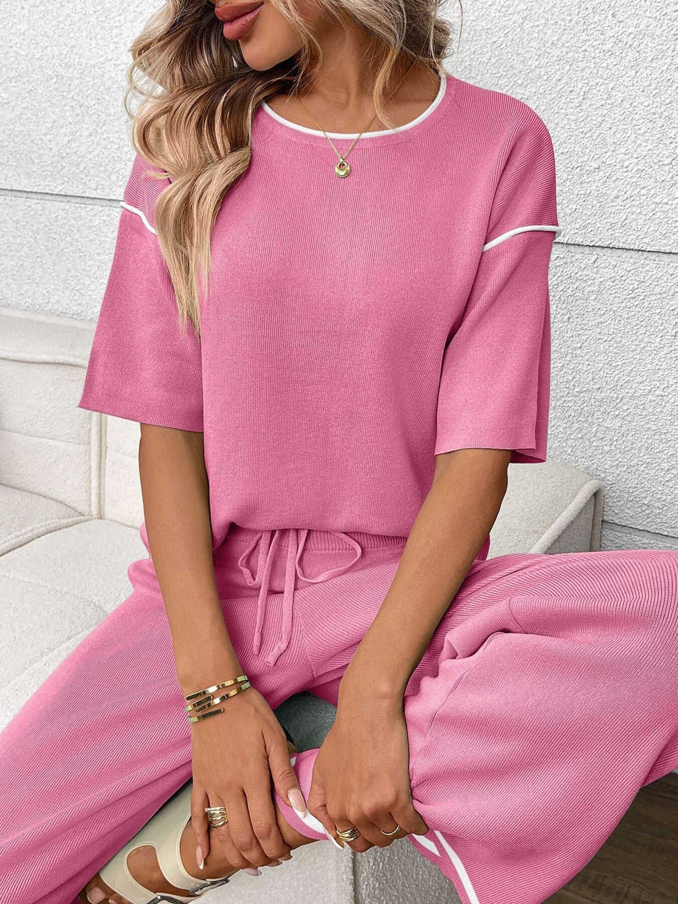 Fuchsia pink ribbed loungewear set with crew neck top and drawstring pants.