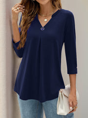 Navy pleated V-neck three-quarter sleeve top with button detail on sleeve cuff.